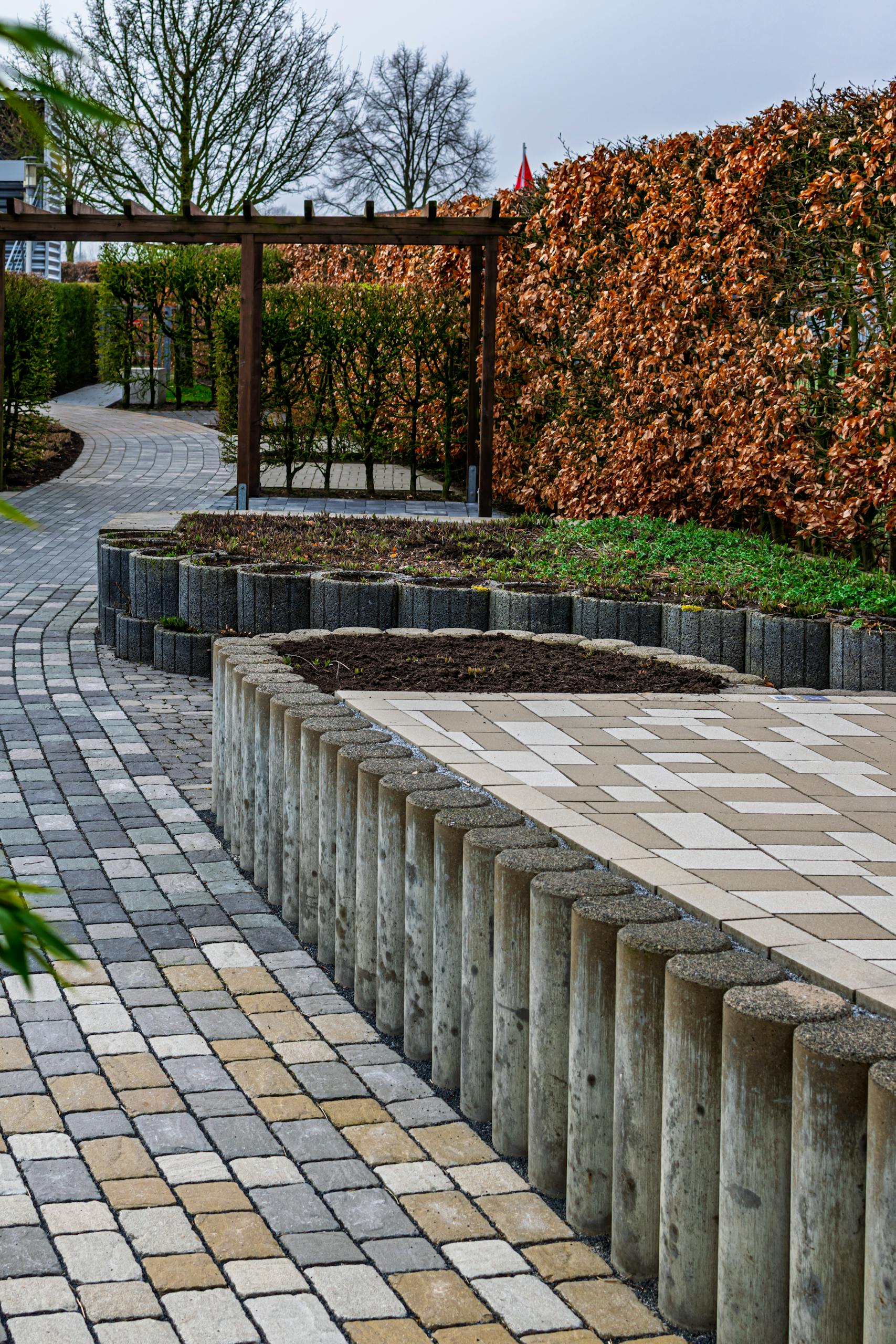 Elegant brick pathway in Coesfeld garden during fall, showcasing geometric landscaping design.